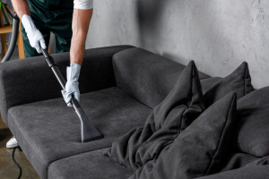 cropped shot of man in rubber gloves using vacuum cleaner and cl